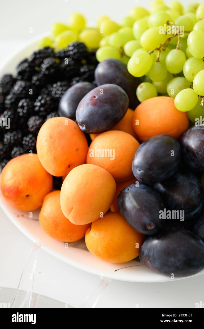 Fruit serving plate, vitamins in the form of fresh fruit, various fruits. Stock Photo
