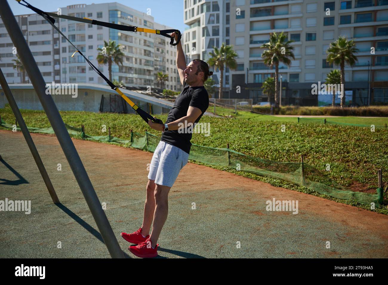 Attractive muscular young adult sportsman, athletic guy exercising with ...