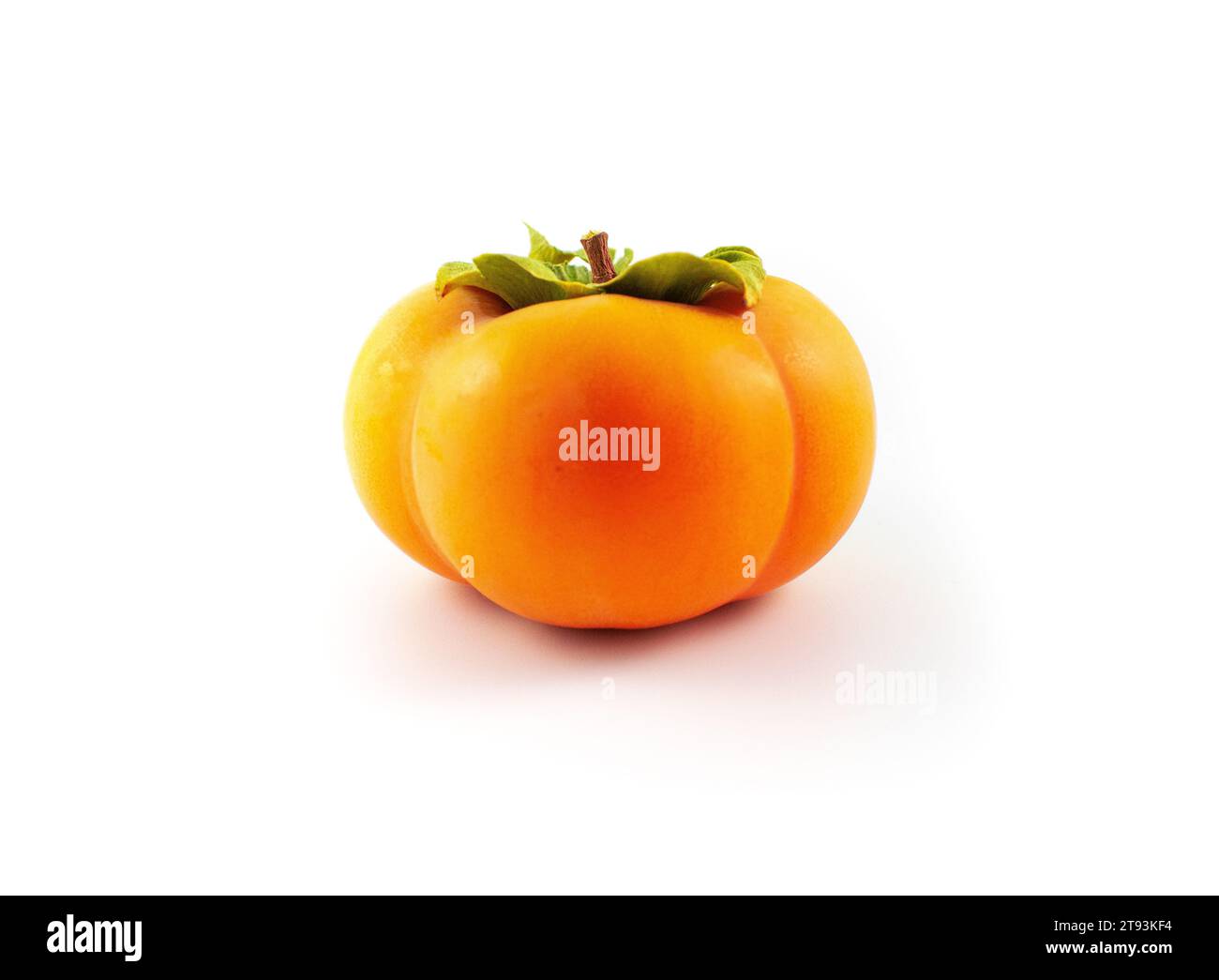Photo of a ripe fuyu Asian persimmon with leaves and stem intact Stock Photo