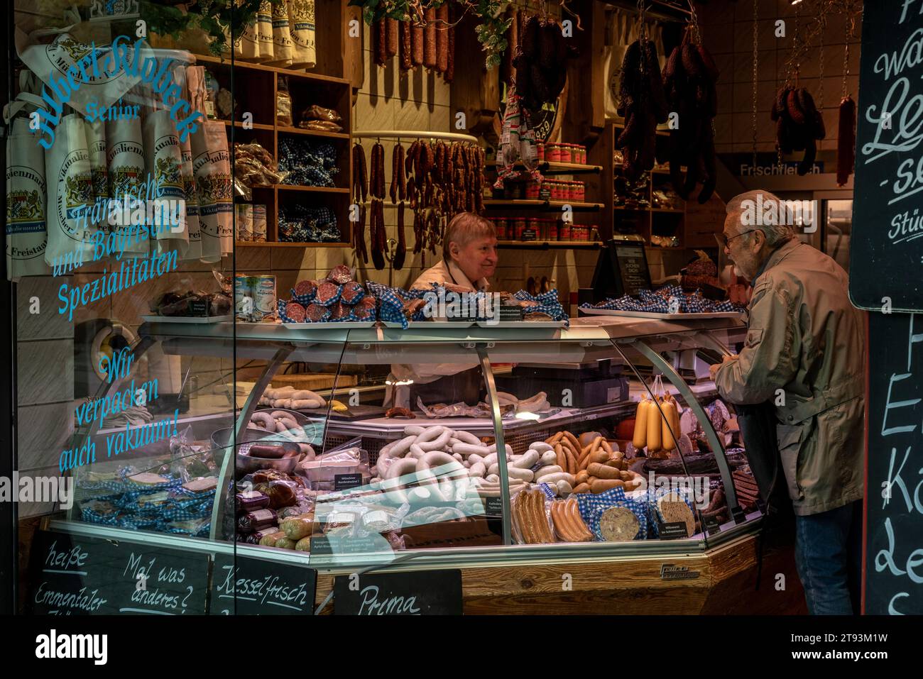 Saleswoman and Customer at Albert Klobeck Butcher Shop, Viktualienmarkt, Munich, Bavaria, Germany Stock Photo