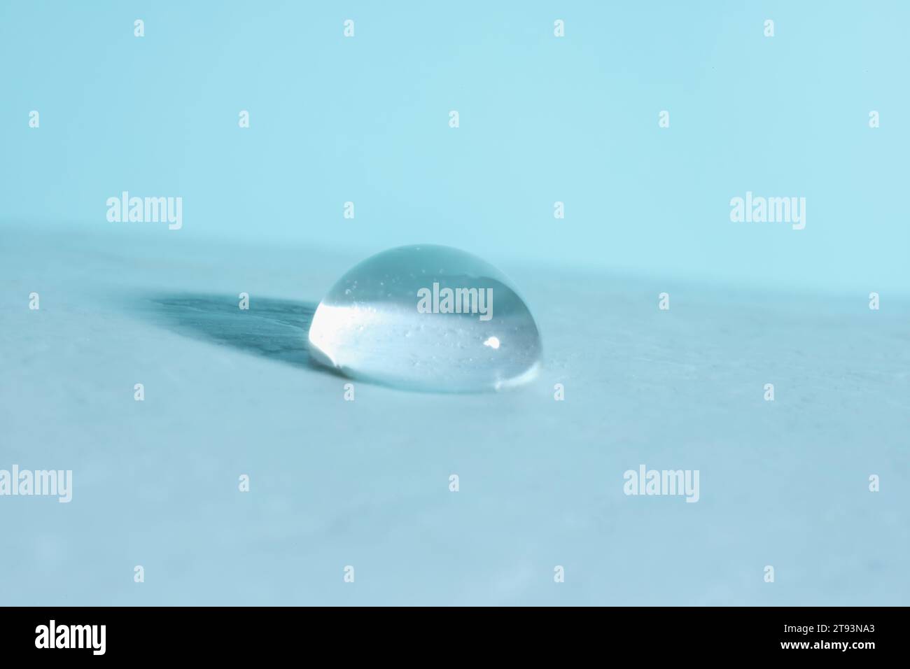 Macro photo of water drop on light blue background Stock Photo - Alamy