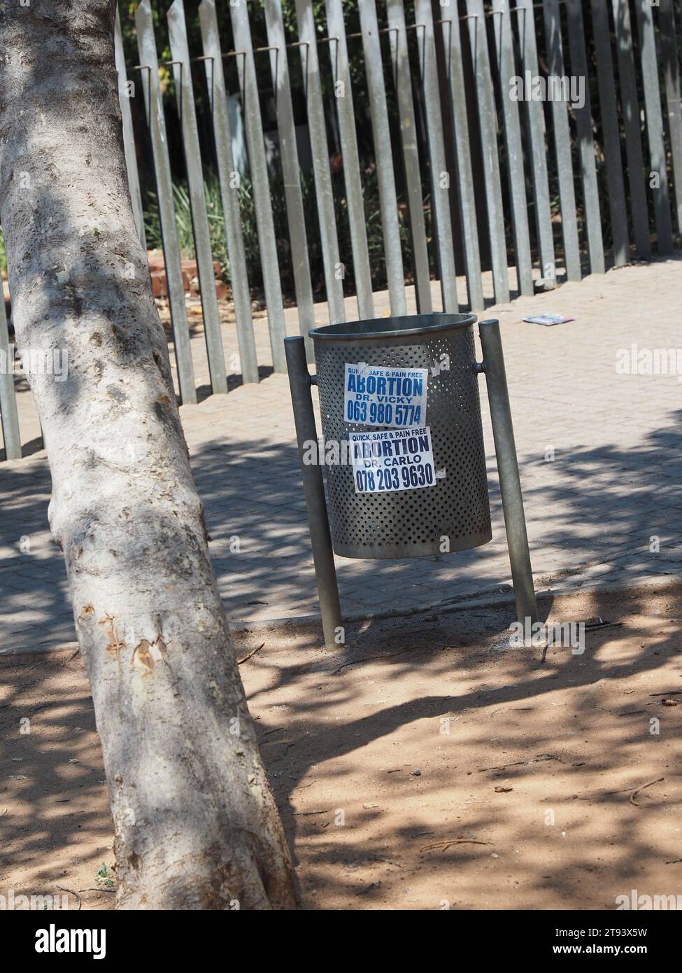 Quick, safe, and pain-free abortion advertising on a rubbish bin in Soweto, Gauteng, South Africa. Stock Photo