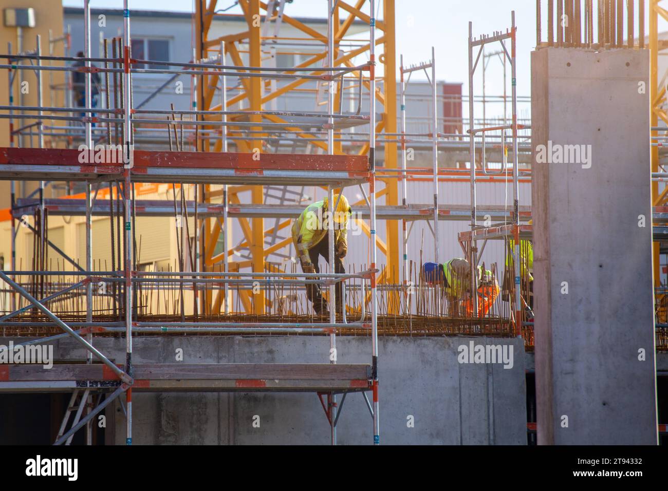 Construction workers working on a large building site Stock Photo