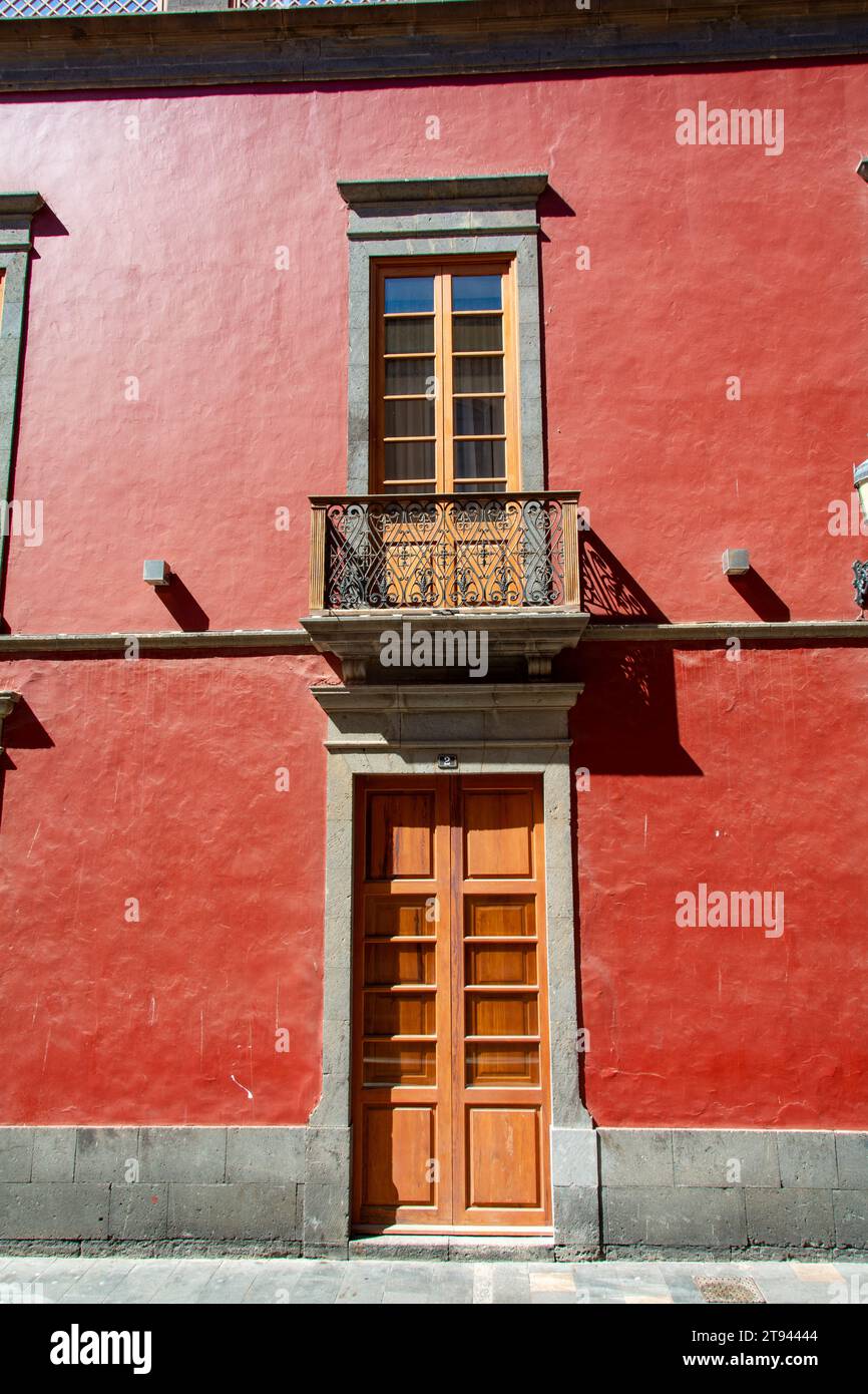 Old window with a balcony and an entrance door on a house on the Canary Island of Gran Canaria in Spain Stock Photo