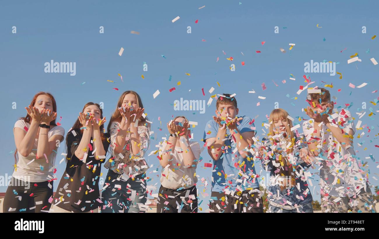 Cheerful woman blowing confetti hi-res stock photography and images - Alamy