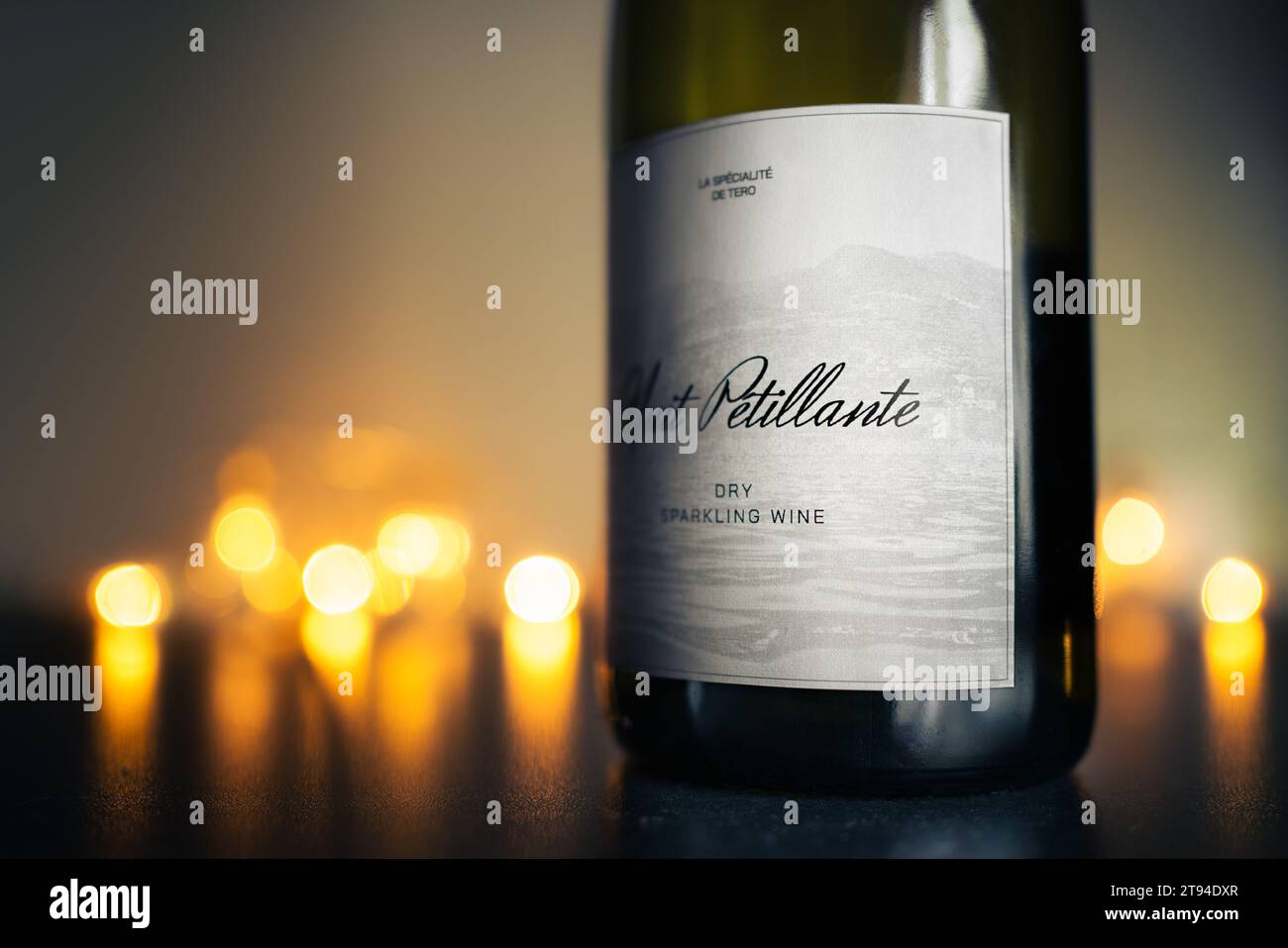 Sparkling wine bottle with lights. Christmas celebration, anniversary dinner or New Year's Eve drink. Vintage label. Mockup luxury brand from Italy. Stock Photo