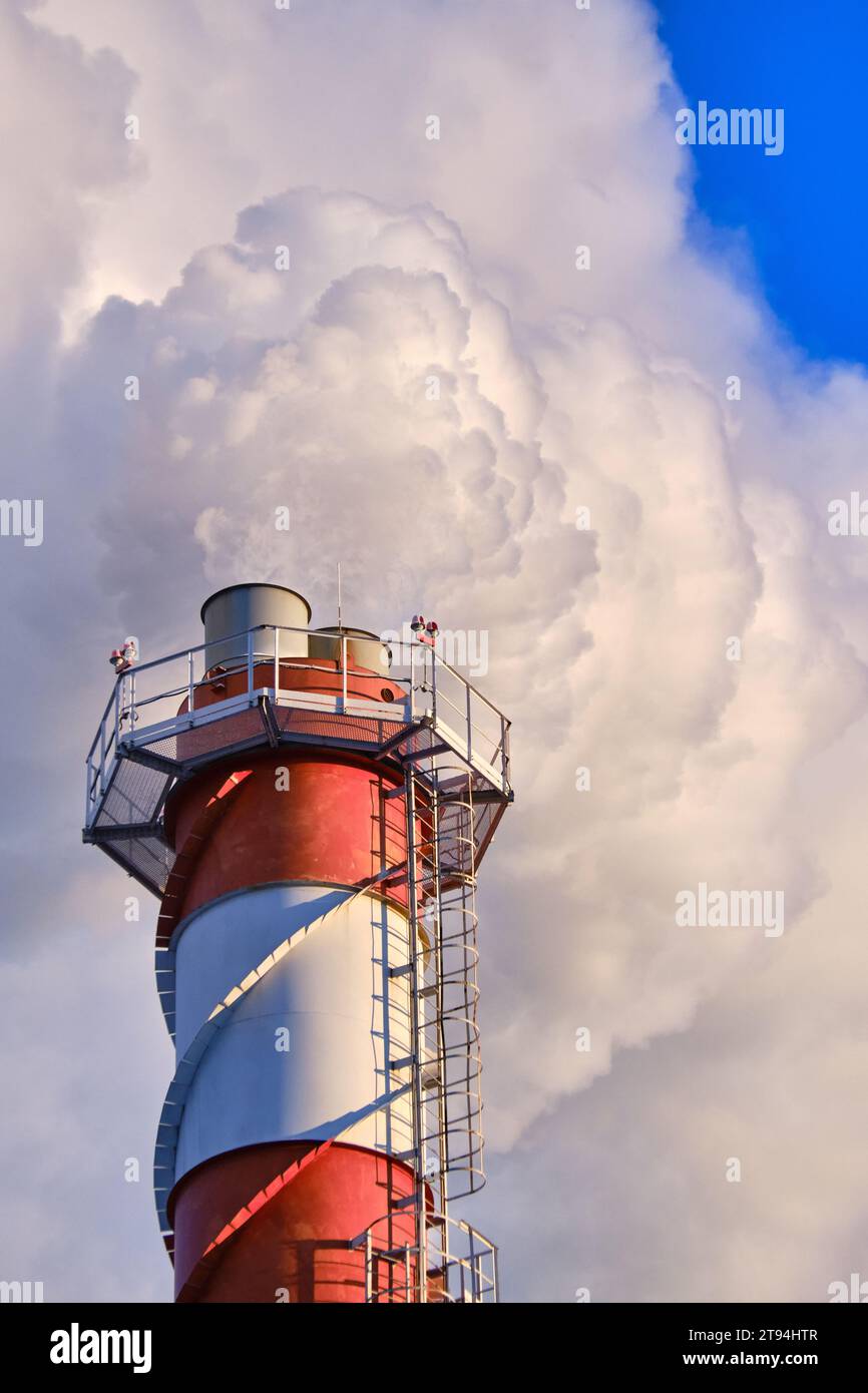 Smoke stack with white steam over blue sky Stock Photo - Alamy