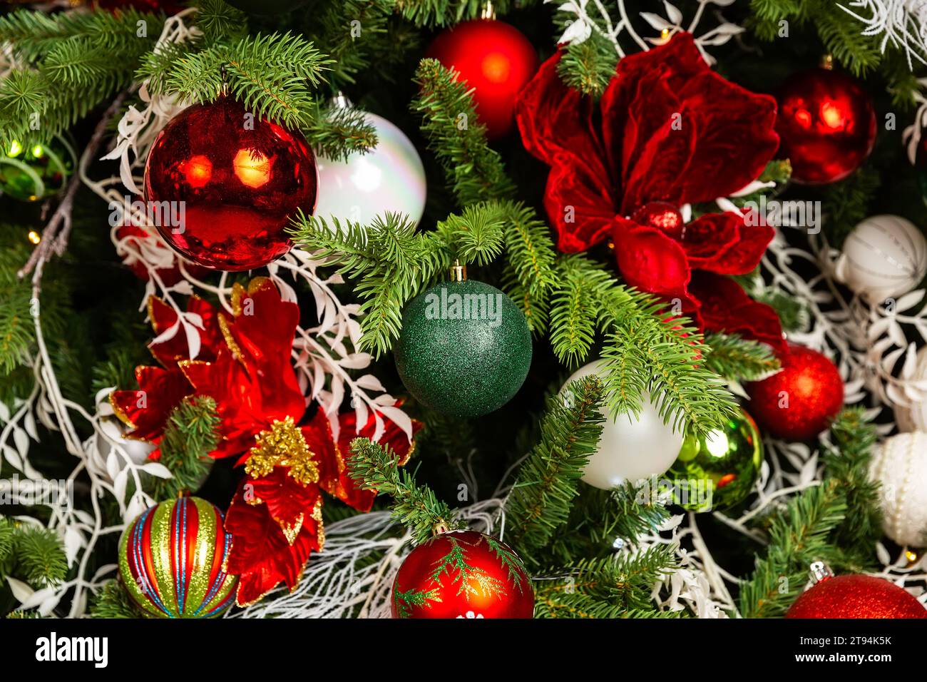 Close up of balls on Christmas tree. Christmas holiday decorations with balls, lights and garland on Christmas tree background. Holiday home decoratio Stock Photo