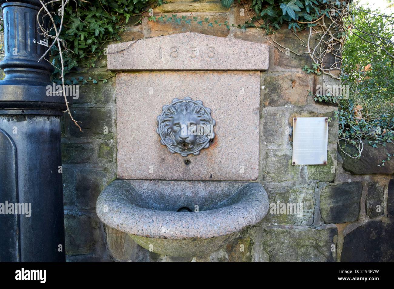 1858 lions head drinking fountain on a railway bridge ormskirk, lancashire, england, uk The fountain provided fresh water to the locals after introduc Stock Photo