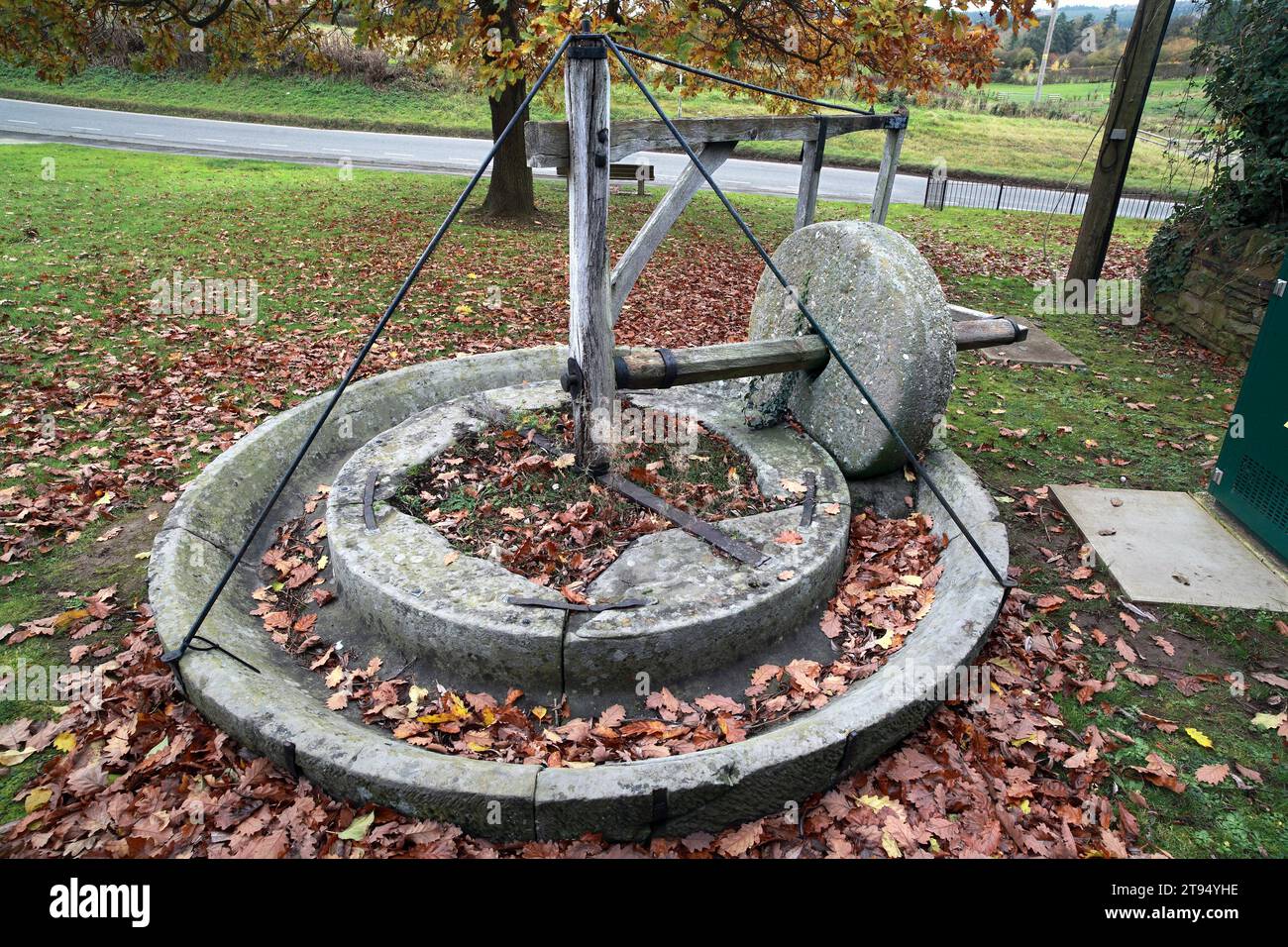 A disused horse-drawn cider mill, with millstone, for crushing apples, Shobdon, Herefordshire. Stock Photo