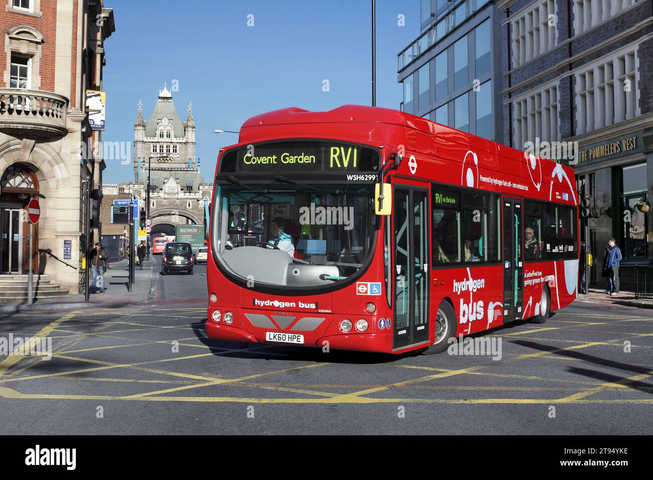 A hydrogen fuel cell powered bus turns into Tooley Street  from Tower Bridge Road, London. (Tower Bridge in the background.) Stock Photo