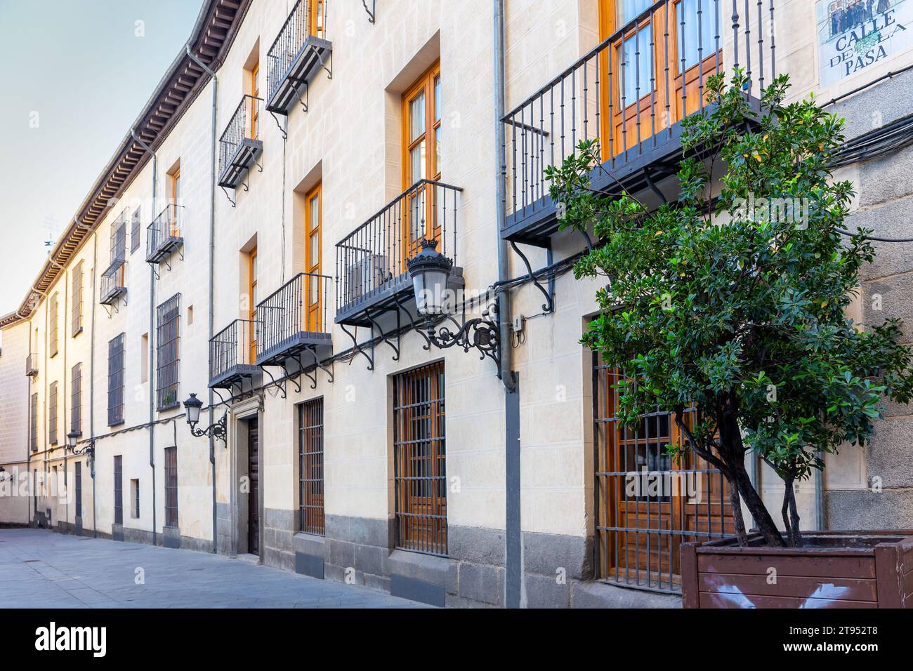 Modern narrow Spanish street in Madrid, Spain, with tiled name "Calle