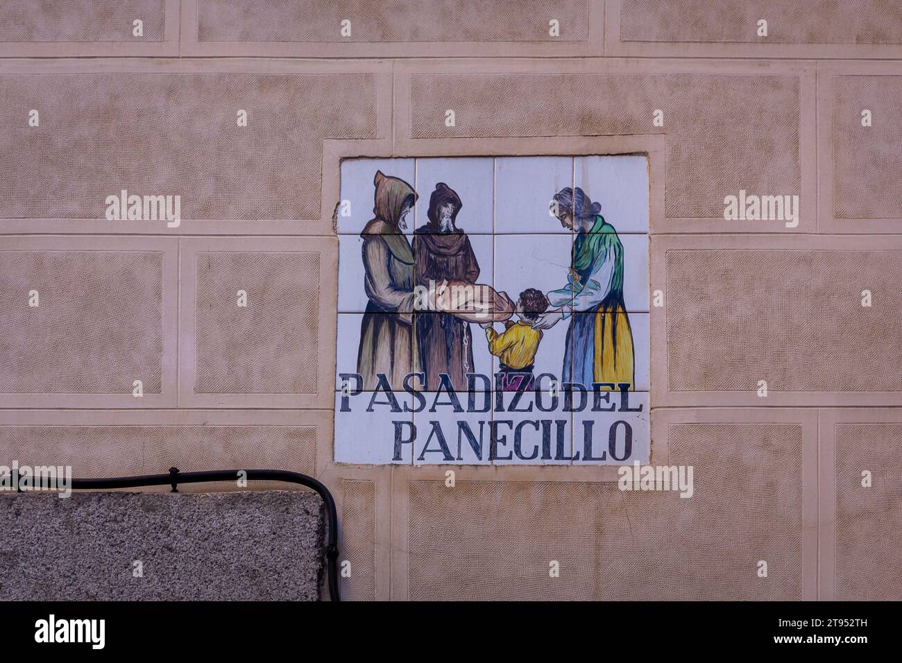 Traditional medieval tiled street sign 'Pasadizo del Panecillo' (translation: The Bread Passage) embedded in the brick building facade in Madrid,Spain Stock Photo