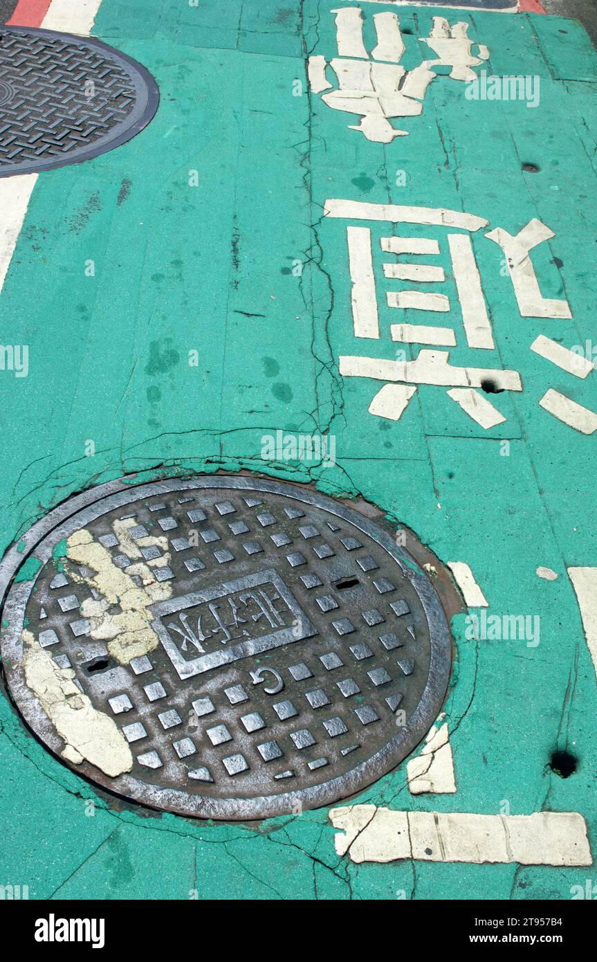 Manhole Cover and Road Markings, Taipei, Taiwan, Asia. Stock Photo