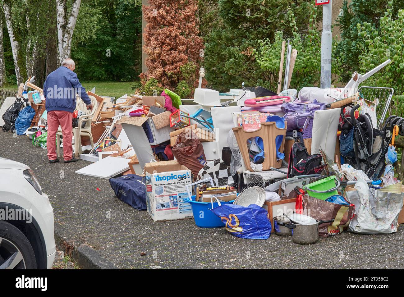 man at a large pile of bulky waste, Germany Stock Photo