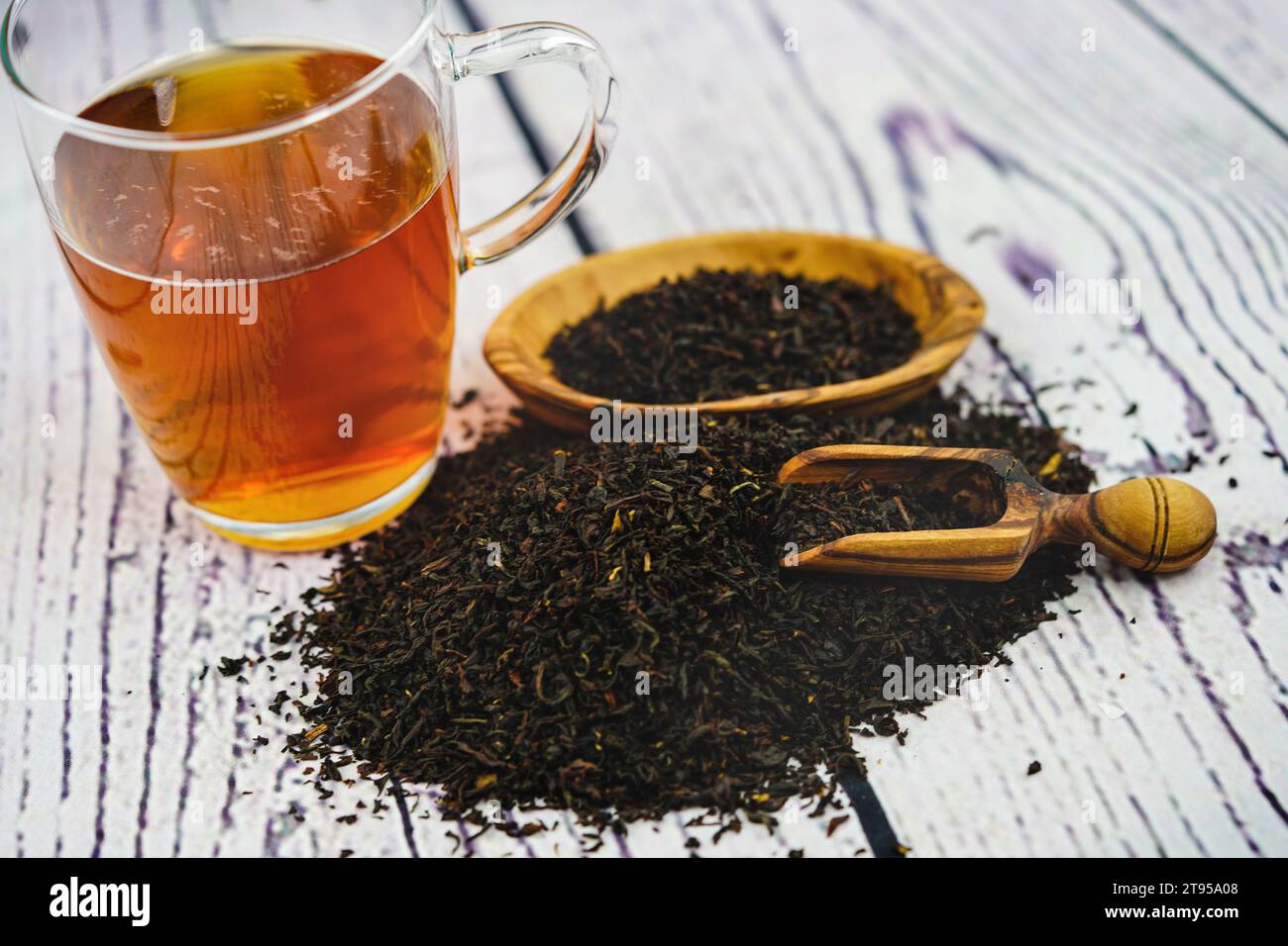 tea glass, dry leaves bowl and wooden spoon Stock Photo