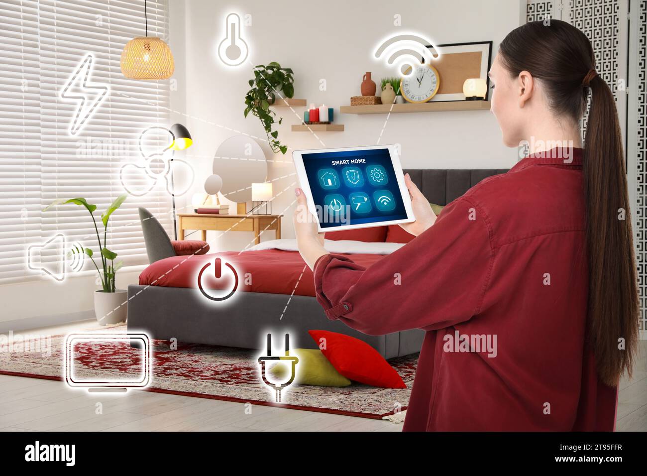 Woman using smart home control system via application on tablet indoors. Different icons connected with device Stock Photo