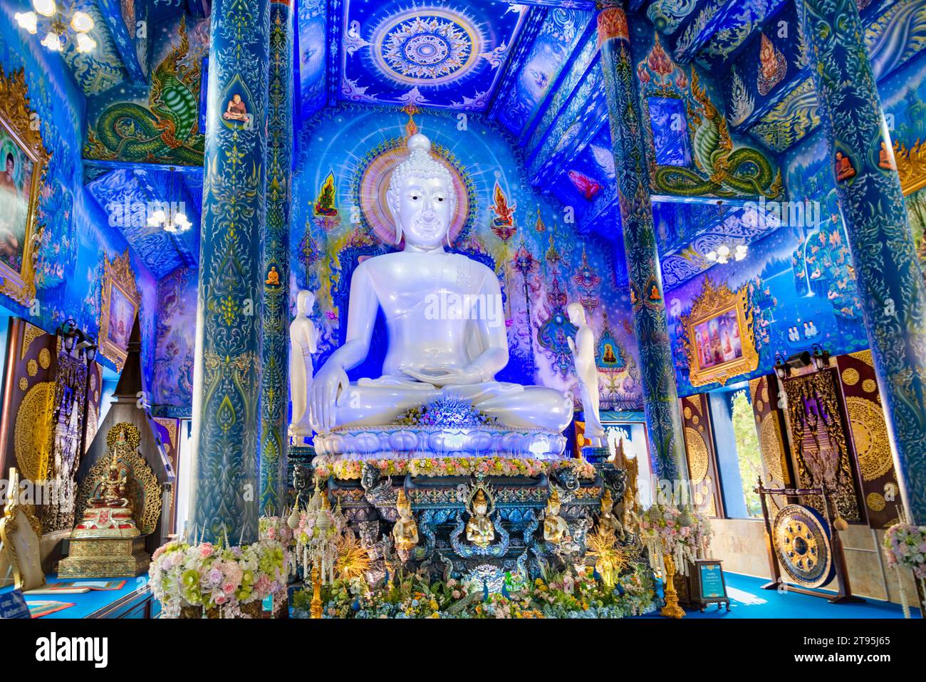 The Blue Temple,Beautifully decorated inside with intricate designs and aqua blue hues,with flowers,ornaments and framed paintings featuring religious Stock Photo