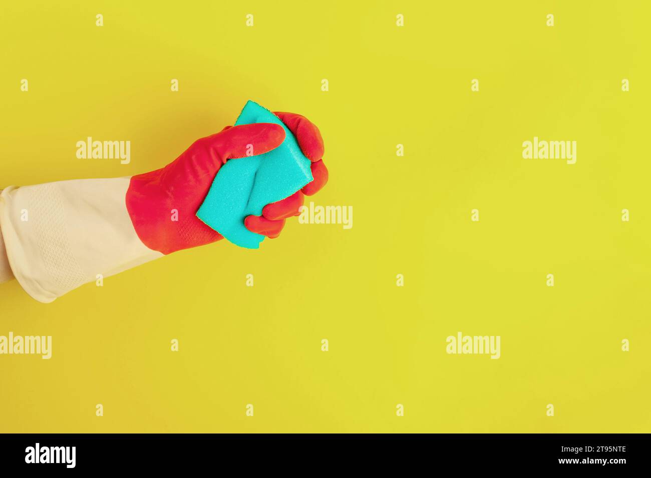 Hand in a rubber glove holds a sponge for washing dishes Stock Photo ...