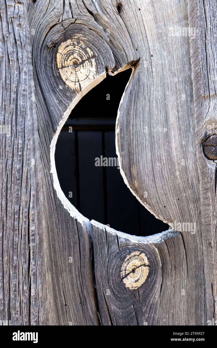 Crescent Moon on wooden door of outhouse - Golden, Colorado, USA Stock Photo