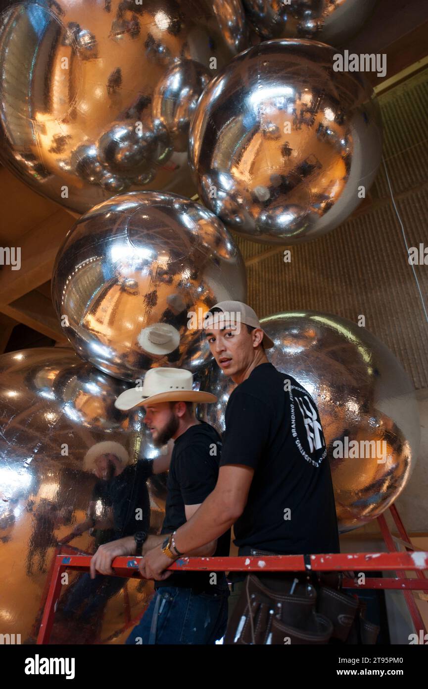 Workers installing shiny balloons for an art opening at the Palm Springs Art Museum in Palm Springs, CA., USA Stock Photo