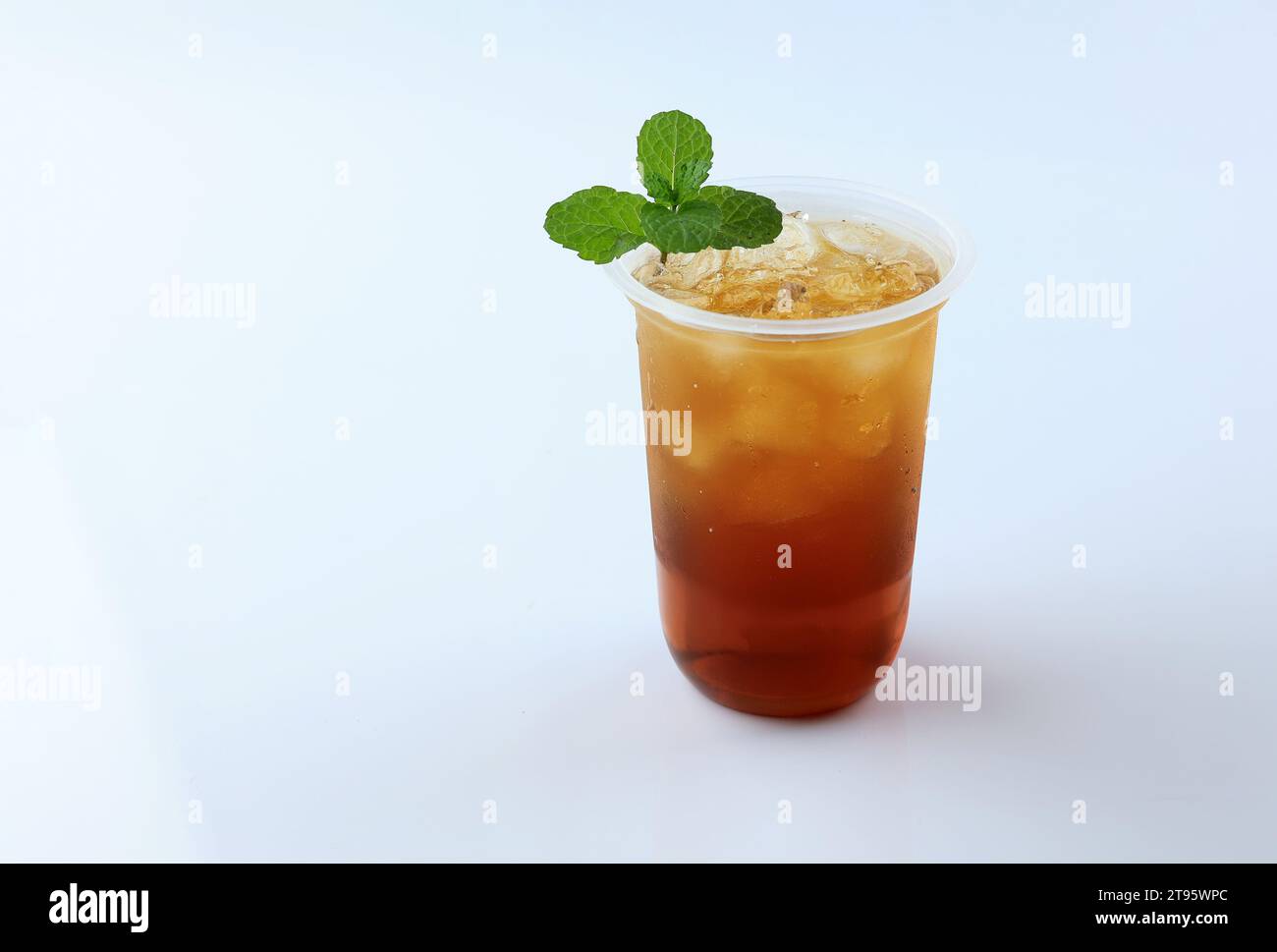 Iced Tea or Es Teh with Mint Leaf Isolated on White Background. Fresh Summer Drink Stock Photo