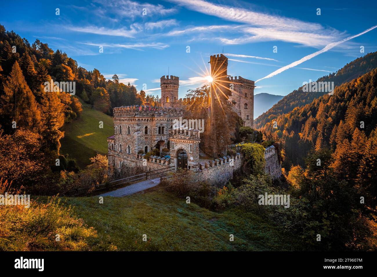 Latzfons, Italy - Beautiful autumn scenery at Gernstein Castle (Castello di Gernstein, Schloss Gernstein) at sunrise in South Tyrol with blue sky, sun Stock Photo