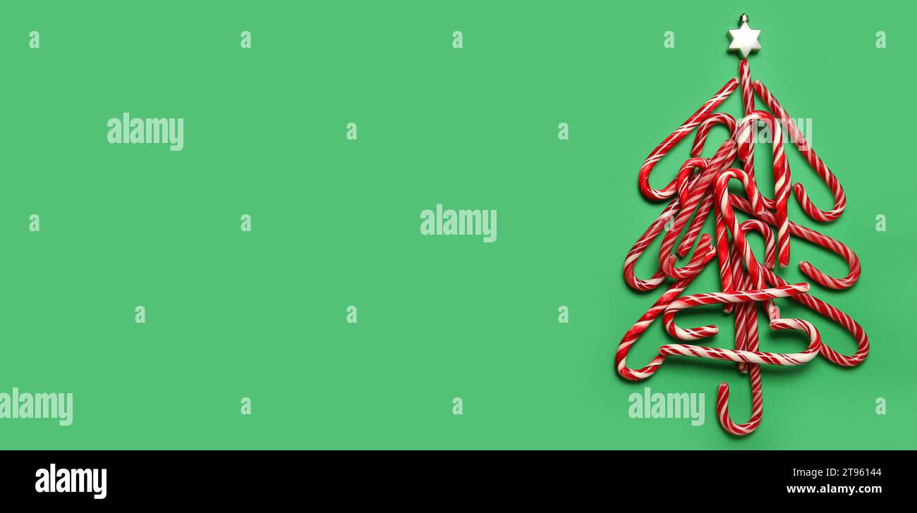Christmas tree made of candy canes on green background with space for ...
