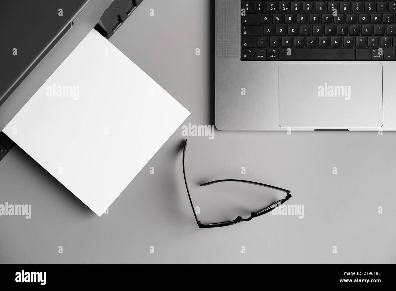 Printer and laptop on grey table in office Stock Photo