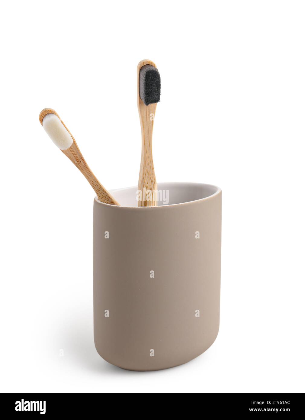 Bamboo tooth brushes in holder on white background Stock Photo - Alamy