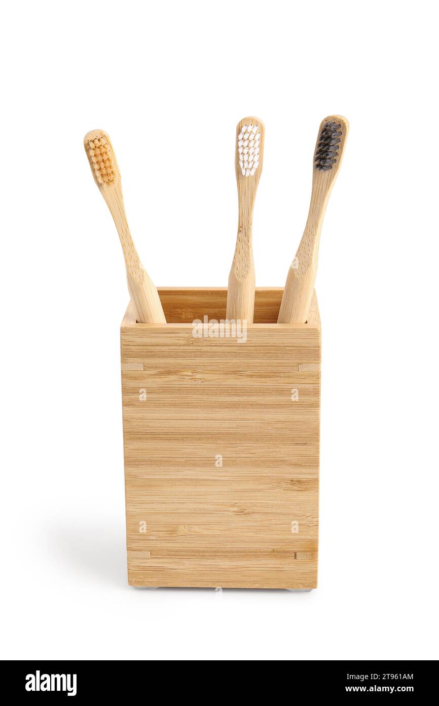 Bamboo tooth brushes in holder on white background Stock Photo - Alamy
