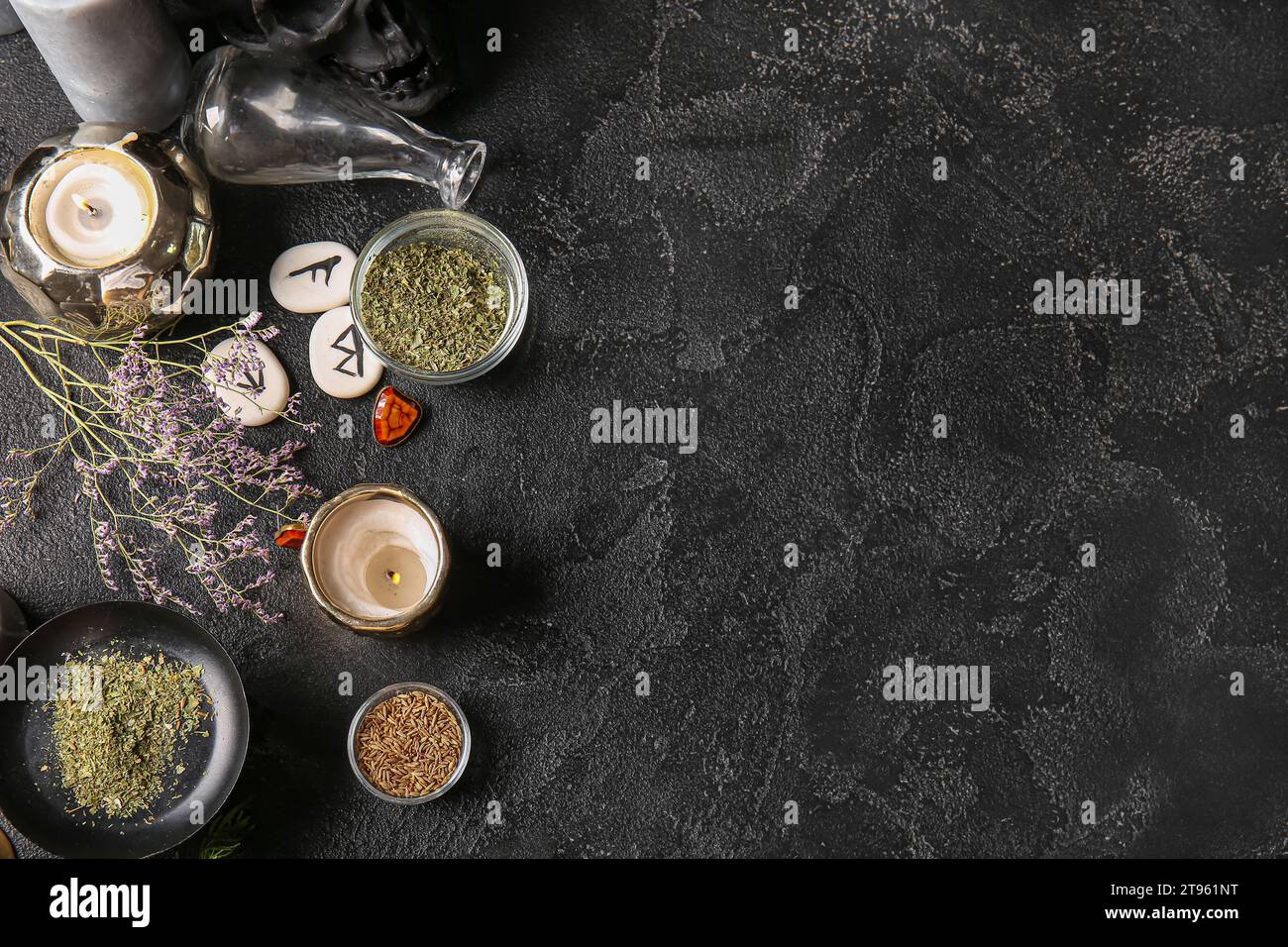 Witch's magic attributes with herbs on dark background Stock Photo - Alamy
