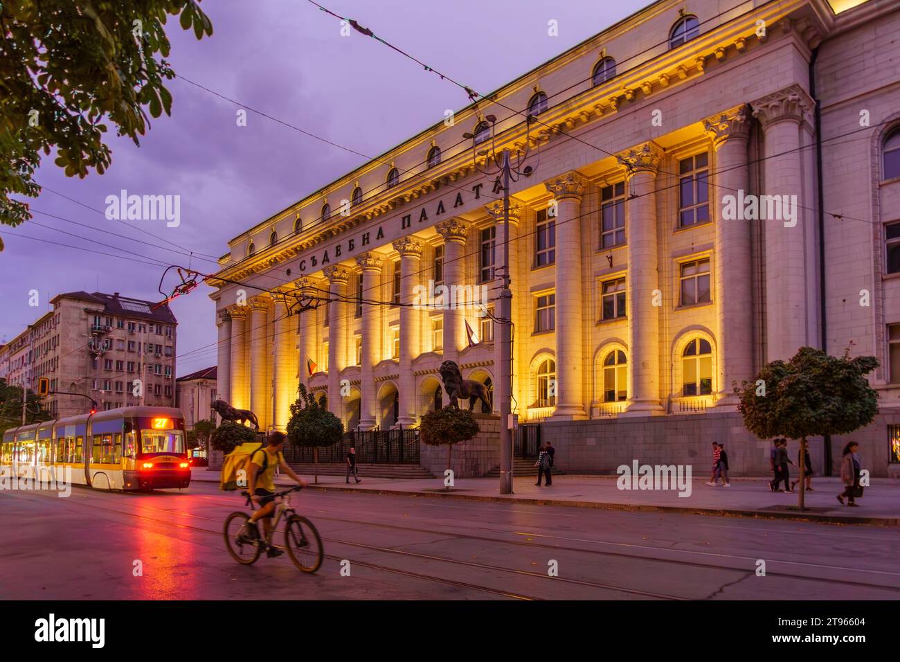 Sofia, Bulgaria - September 14, 2023: Evening view of the City Court building, with a tram, locals, and visitors, in Sofia, Bulgaria Stock Photo
