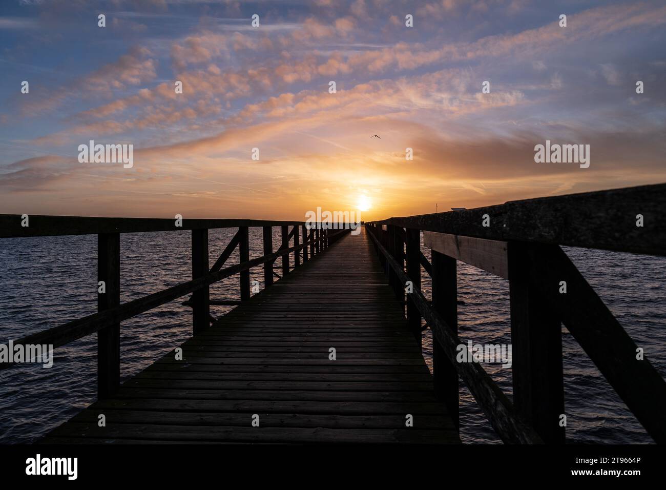 A scenic view of a pier at sunset in Bjarred, Sweden Stock Photo