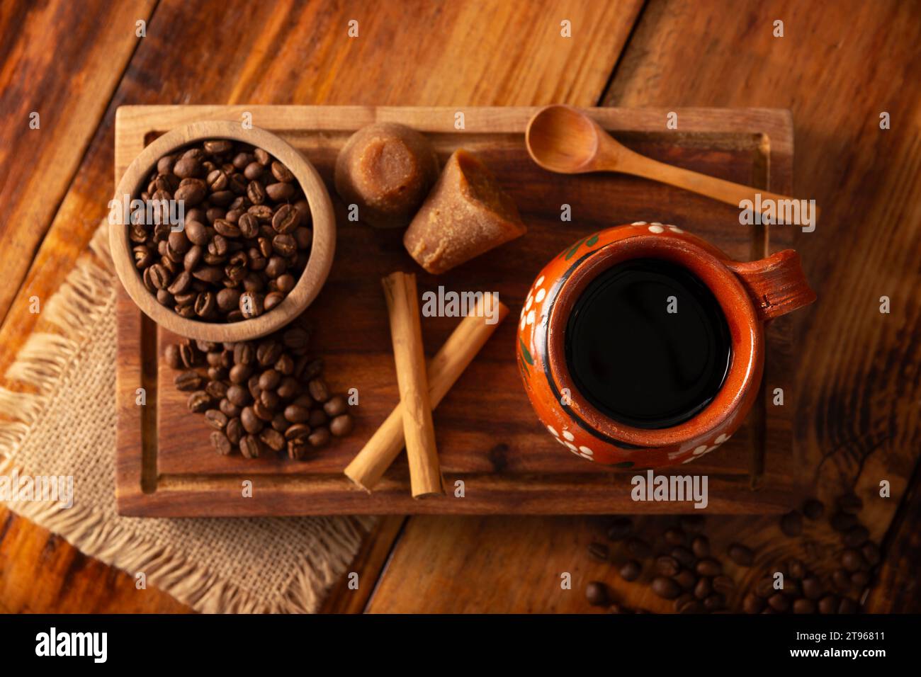 Cafe de Olla, Mexican-style coffee prepared with roasted and ground coffee beans, cinnamon and piloncillo. Traditional recipe prepared in a clay pot a Stock Photo