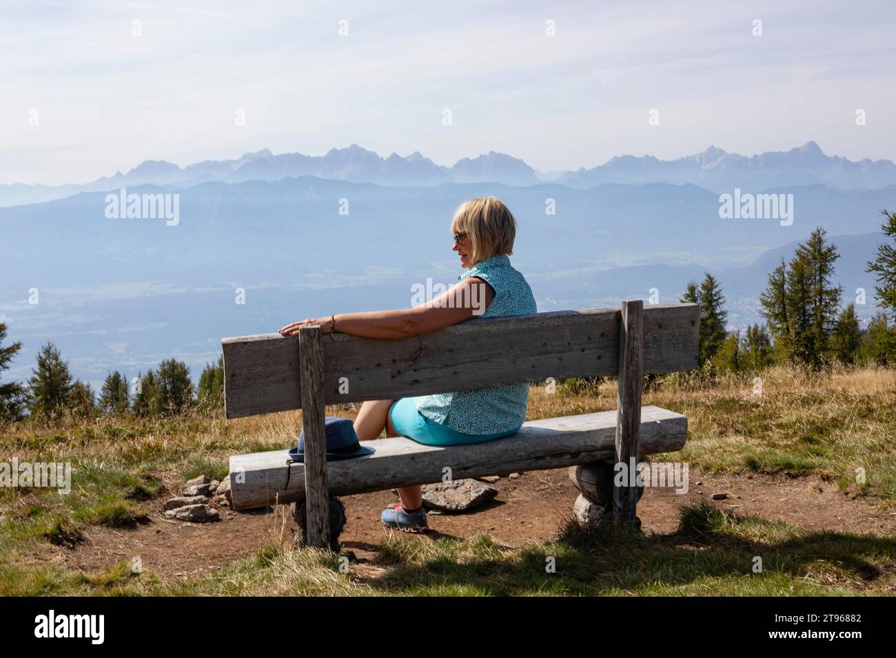 Hiker sitting on a viewing bench on the Gerlitzen, Gerlitzen Alpe, Nockberge, Gurktaler Alps, Carinthia, Austria Stock Photo