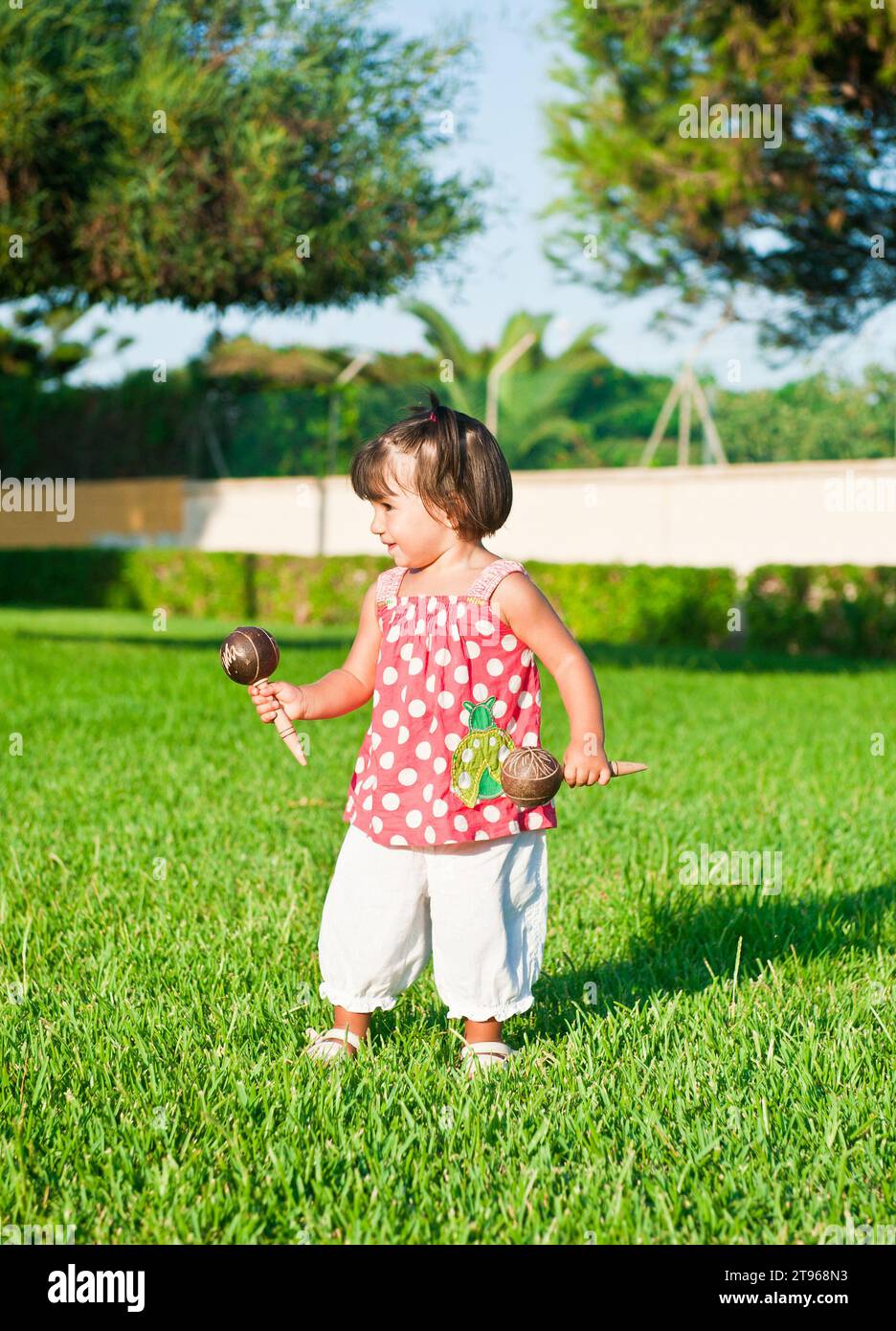 Little girl playing in the streets with tambourines Stock Photo Alamy