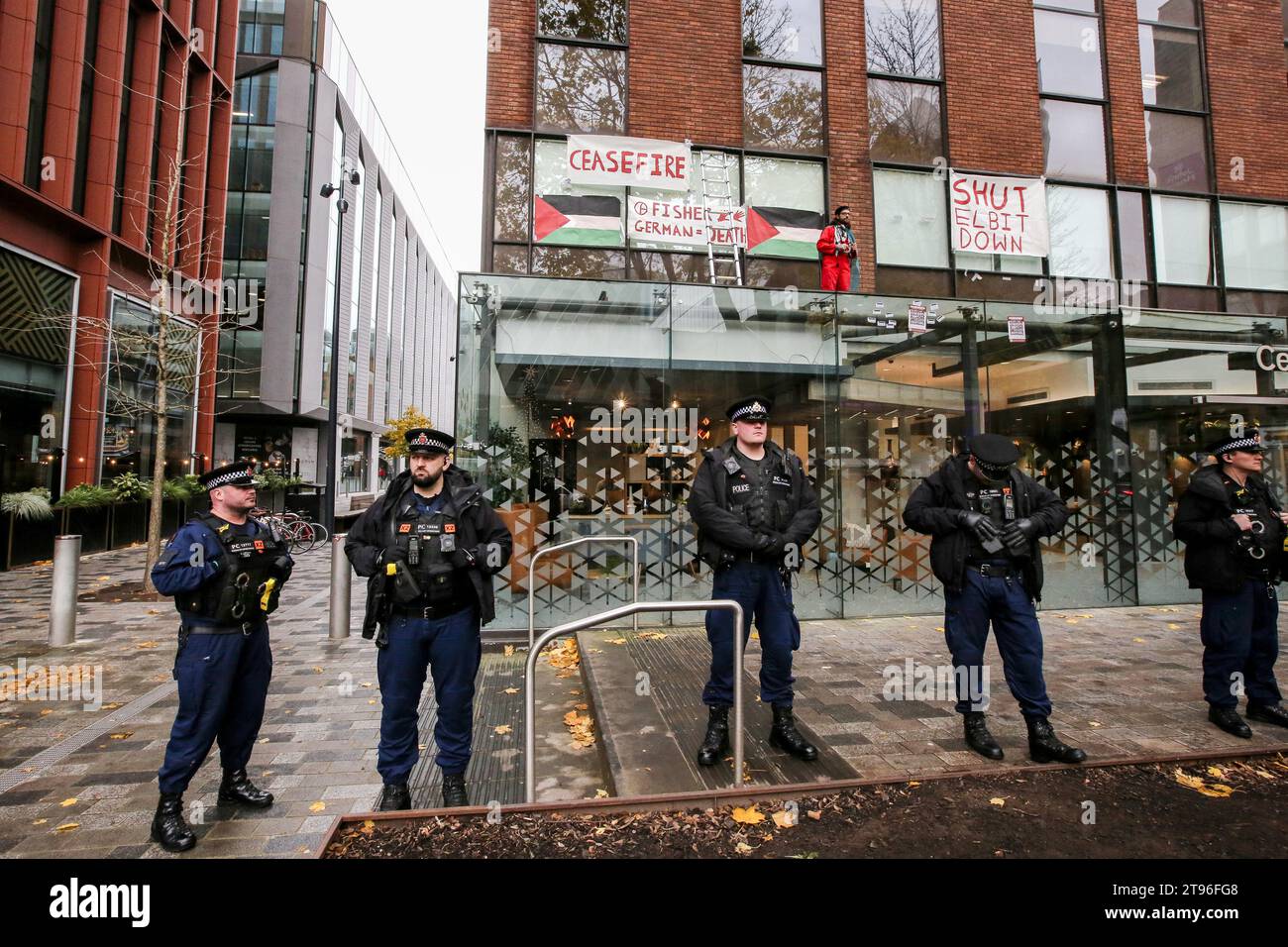 An activist from Palestine Action occupies the glass roof of Centurion