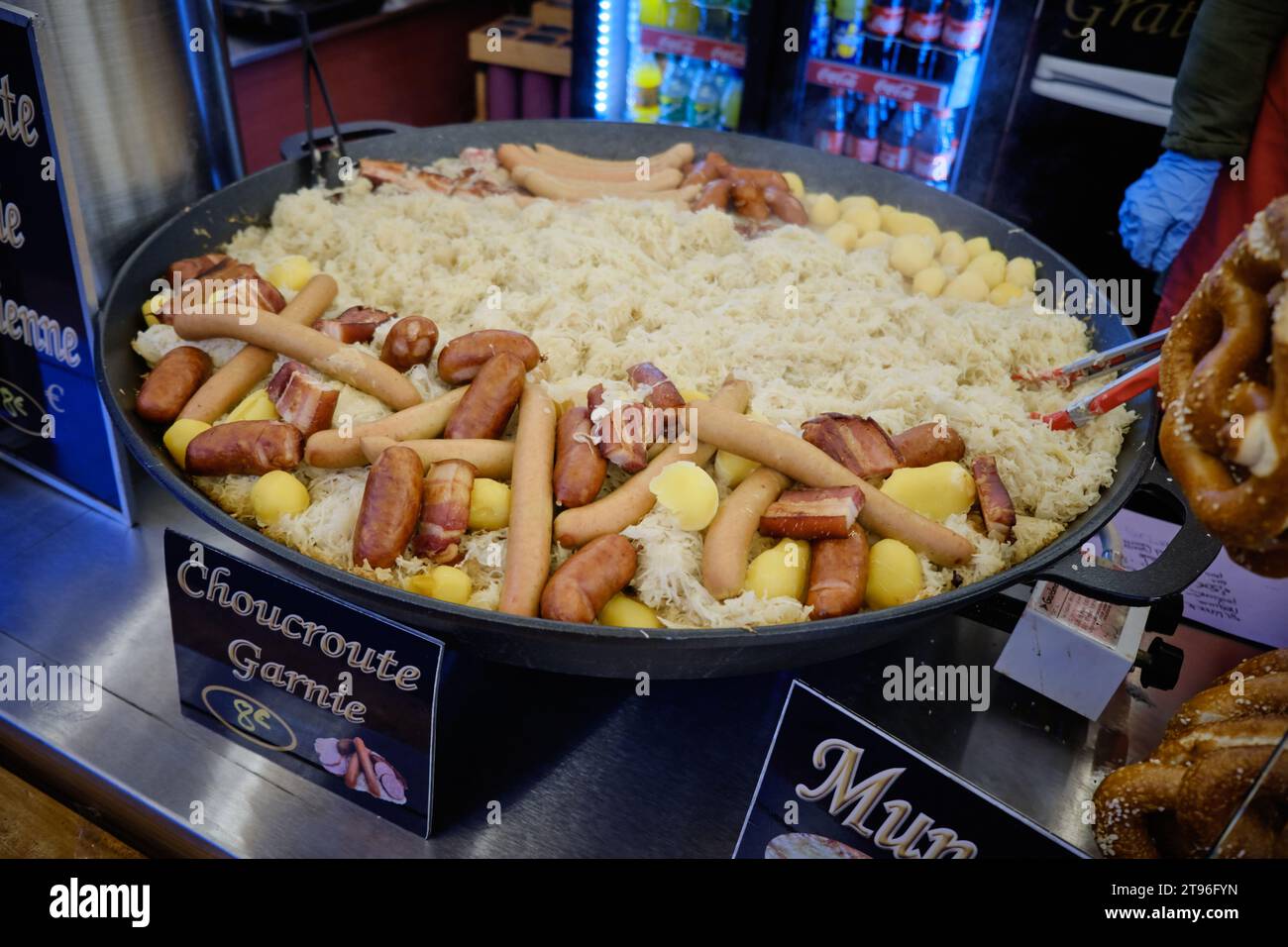 Large skillet full of Choucroute Garnie (Sourkraut) on display and for sale at a food stall at the Strasbourg Christmas Market Stock Photo
