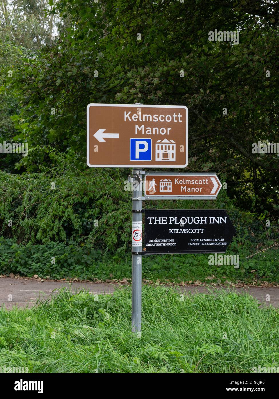 Signpost in the village of Kelmscott, Oxfordshire. UK; showing directions to Kelmscott Manor and the Plough Inn Stock Photo