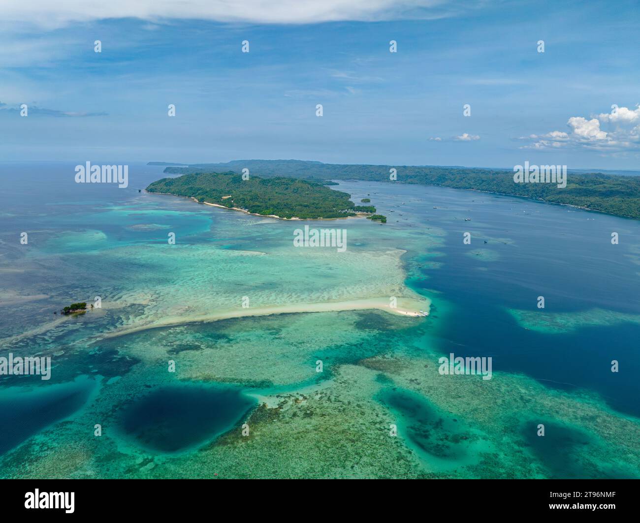 Tropical Island and sandbar surrounded by azure water and reefs. Barobo, Surigao del Sur. Philippines. Stock Photo