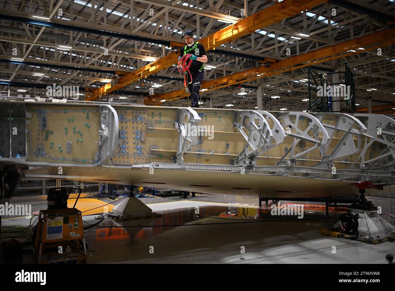 Workers on the Airbus A350 wing manufacturing floor at the Airbus North Factory, Broughton, Chester, North Wales, during a visit by Chancellor of the Exchequer Jeremy Hunt following his Autumn Statement. Picture date: Thursday November 23, 2023. Stock Photo