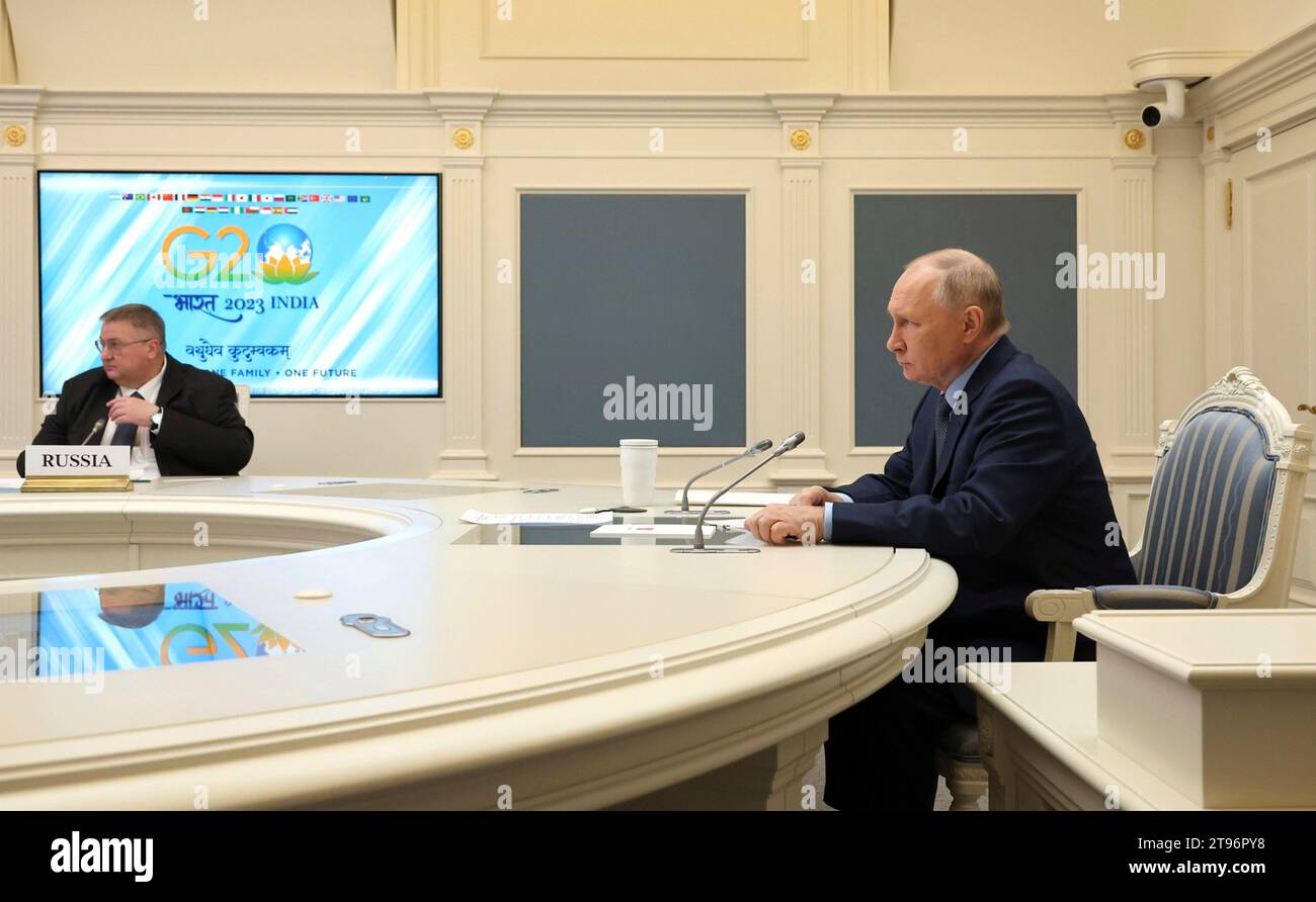 Moscow, Russia. 22nd Nov, 2023. Russian President Vladimir Putin, right, and Deputy Prime Minister Alexei Overchuk, left, take part in a an extraordinary G20 summit hosted by Indian Prime Minister Narendra Modi via video link from the Kremlin, November 22, 2023 in Moscow, Russia. Credit: Mikhail Klimentyev/Kremlin Pool/Alamy Live News Stock Photo