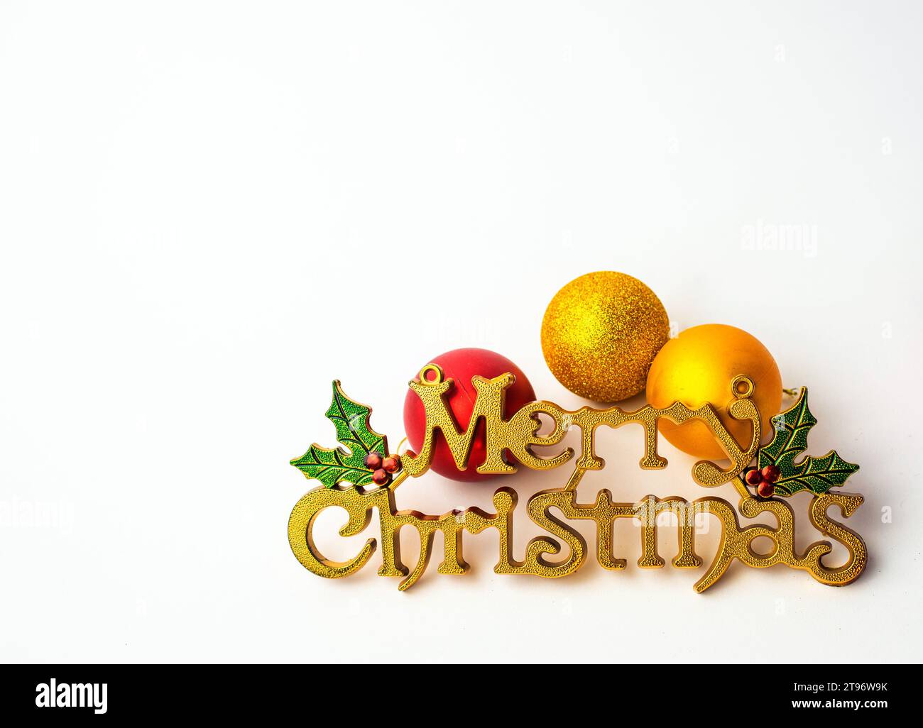 Yellow - Merry Christmas Icon on a Plain white backdrop with xmas balls Stock Photo