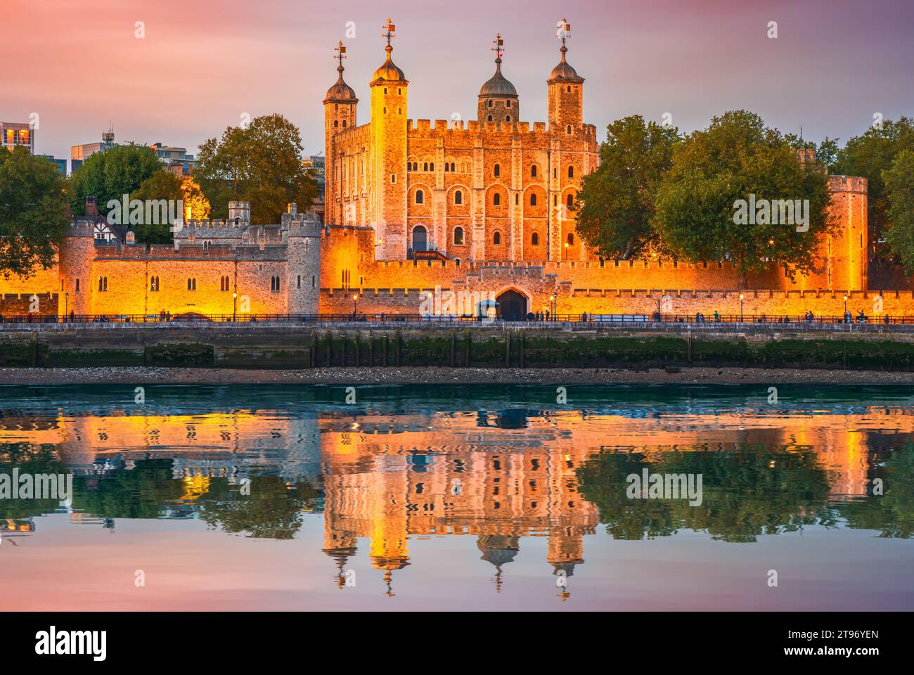 London, England. The Tower of London by the river Thames, United Kingdom capital spotlight, twilight illuminated scene. Stock Photo