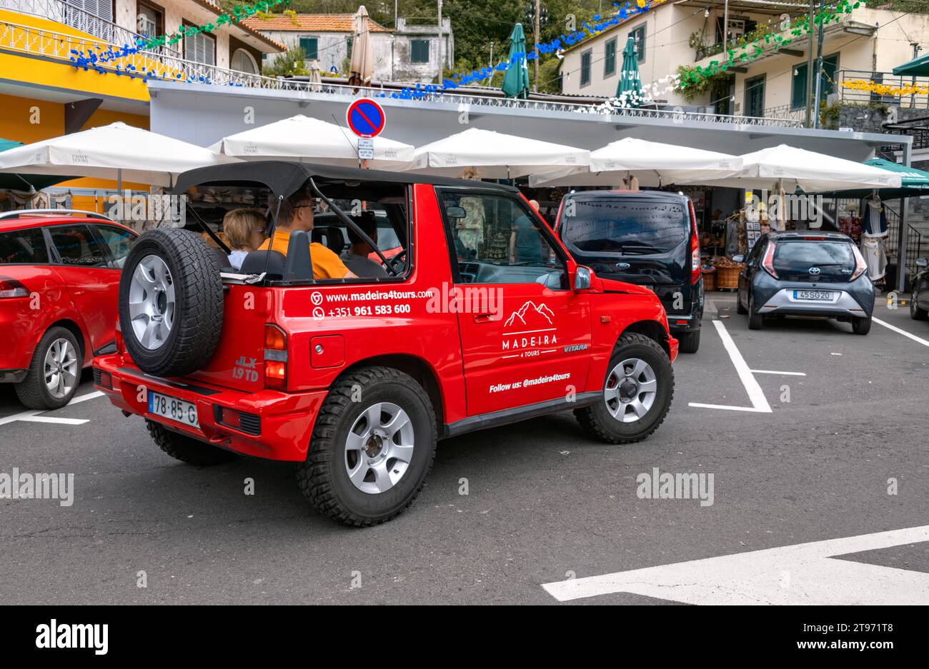 Red Suzuki tourist jeep with tourists in the village of Curral das Freiras, Madeira, Funchal Portugal Stock Photo