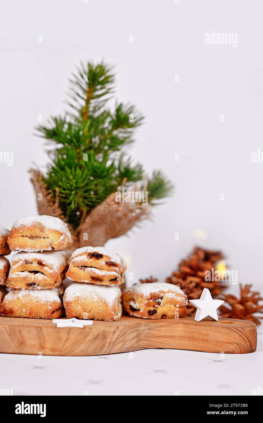 Small German Stollen cake pieces, a fruit bread with nuts, spices, and dried fruits with powdered sugar traditionally served during Christmas time Stock Photo