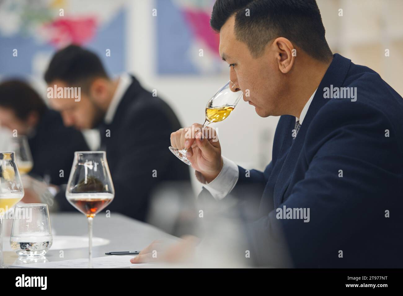 Professional sommelier sniffing unknown whiskey during blind tasting