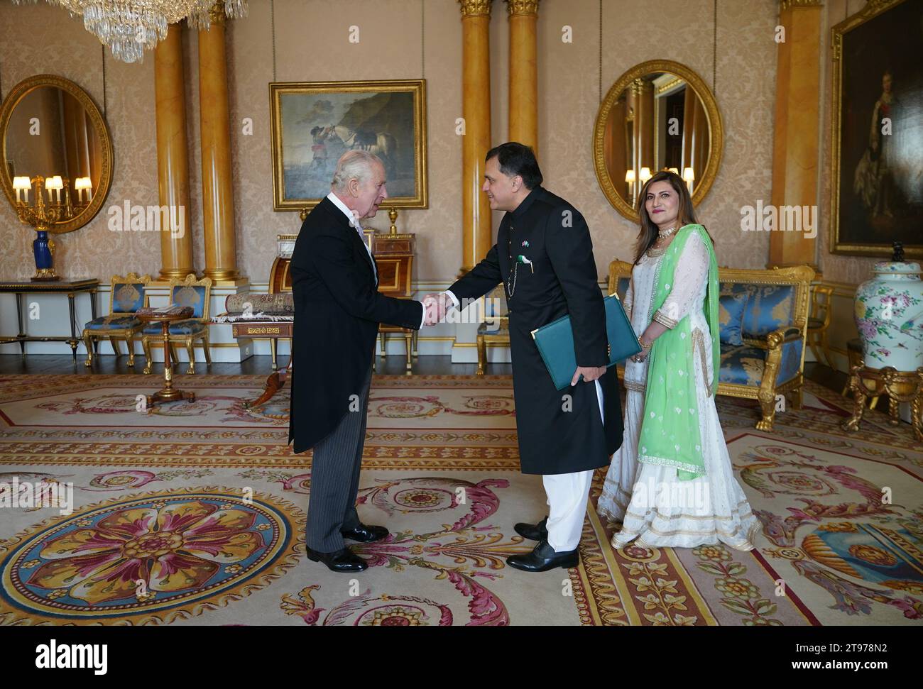 King Charles III (left) receives Dr. Mohammad Faisal, High Commissioner for the Islamic Republic of Pakistan in London, and his wife Sarah Naeem, during a private audience at Buckingham Palace, London. Picture date: Thursday November 23, 2023. Stock Photo