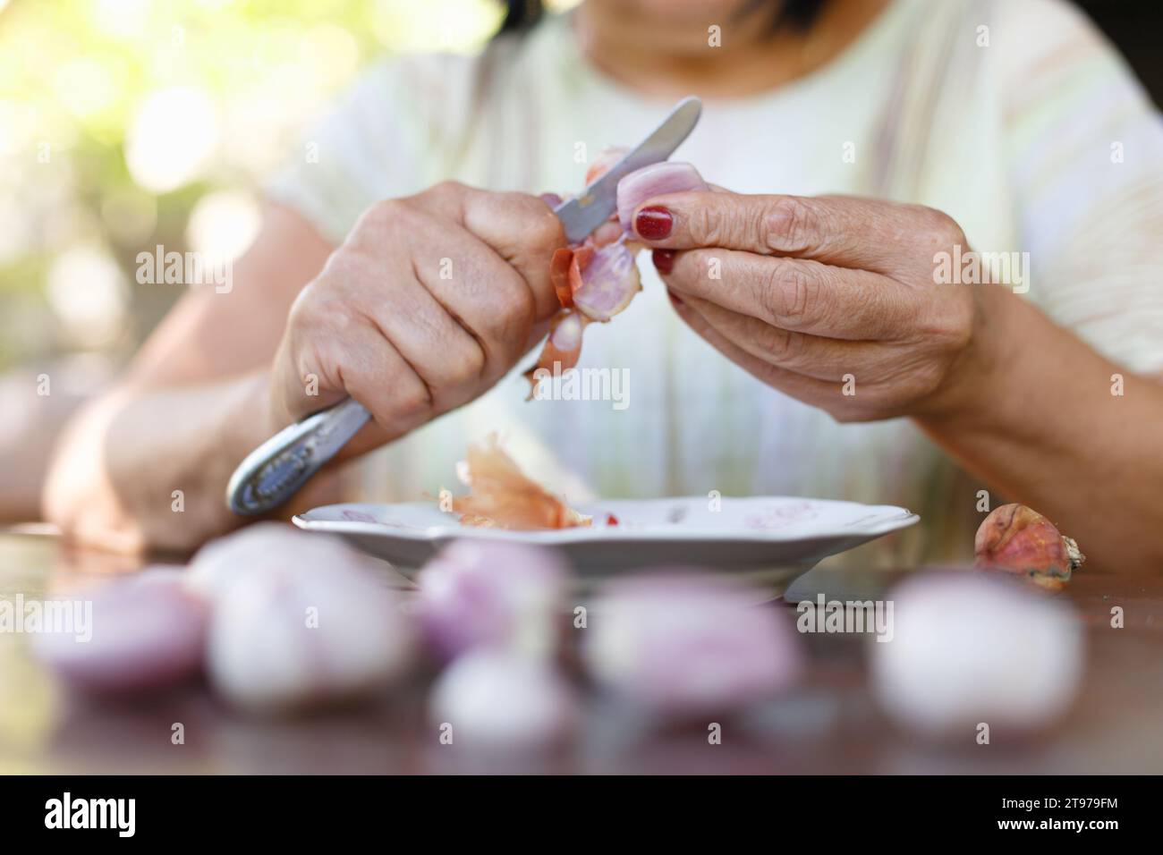 Woman peeling an onion hi-res stock photography and images - Alamy